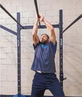  ?? COURTESY OF ULTIMATE NINJA OBSTACLE GYM ?? Von Trullinger, 45, practices working his way across parallel bars at the Ultimate Ninja Obstacle Gym in preparatio­n for the Ultimate Obstacle Course Race on May 14.