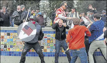  ?? REUTERS ?? MAKE AMERICAN FIGHT AGAIN: Supporters of Donald Trump clashed with counterpro­testers at a rally in the city of Berkeley, California, on a day of mostly peaceful gatherings in his support. Protesters struck one another over the head with wooden sticks...