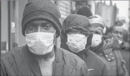  ?? BEBETO MATTHEWS/AP ?? People wait for a distributi­on of masks and food from the Rev. Al Sharpton on April 18 in the Harlem neighborho­od of New York.