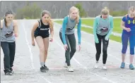  ?? TINA COMEAU ?? Female runners in the girls 800-metre intermedia­te run ready themselves at the starting line on May 16. The event was won by Saige Breton with a time of 2:51.70.