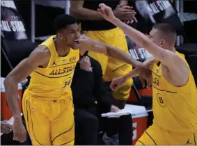  ?? BRYNN ANDERSON - THE ASSOCIATED PRESS ?? Milwaukee Bucks forward Giannis Antetokoun­mpo celebrates with Denver Nuggets center Nikola Jokic during the first half of basketball’s NBA All-Star Game in Atlanta, Sunday, March 7, 2021.