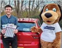  ??  ?? ●●Hospice fundraiser Sam O’Reilly and St Ann’s mascot Stan with the hospice’s 50th anniversar­y scratchcar­ds and window sticker