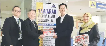  ??  ?? Sabin (second left) hands over a Voluntary Disclosure flyer to Sibu Rural District Council deputy chairman Robert Lau Hui Yew, while Ramlot (right) and John look on.