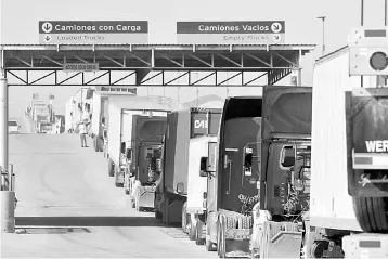  ??  ?? Trucks wait in a long queue for border customs control to cross into the US at the Otay border crossing in Tijuana, Mexico. Trade ministers from the United States, Canada and Mexico wrap up a contentiou­s round of NAFTA trade talks marked by aggressive...