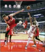  ?? CHARLES REX ARBOGAST — THE ASSOCIATED PRESS ?? The Bulls’ Dwyane Wade (3) shoots as the Wizards’ Jason Smith tries to defend during the first half Wednesday in Chicago.