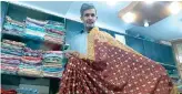  ?? AN photo by Zulfiqar Kunbhar ?? Merchant Zafar Abbas Ansari shows sari fabric at his shop in Banarsi Silk Weavers Colony in Khairpur, Sindh.