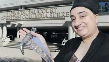  ?? JASON PAYNE/ PNG ?? Sukhvinder Kaur Vinning, executive director of the World Sikh Organizati­on of Canada, holds a kirpan outside Surrey provincial court Wednesday. Kirpans are stylized knives worn by initiated Sikh men and women.