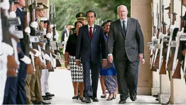  ?? — AFP ?? Official visit: Widodo inspecting a guard of honour while being accompanie­d by Australian GovernorGe­neral Peter Cosgrove at Admiralty House in Sydney.