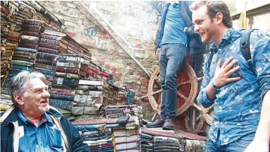  ??  ?? Frizzo (left) persuading a visitor to climb the ‘bookstairs’ seen in the background.