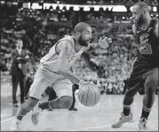  ?? ASSOCIATED PRESS] [MICHAEL DWYER/THE ?? Boston guard Kyrie Irving drives past Cleveland’s LeBron James, his former teammate on the Cavaliers, during the first quarter of Sunday’s game in Boston.