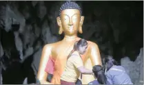  ?? Picture: AP/African News Agency (ANA) ?? ANSWERED PRAYERS: Family members pray in front of a Buddhist statue near the cave where 12 boys and their soccer coach were trapped.