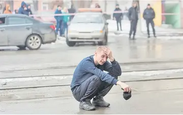  ??  ?? A man reacts at the scene of the fire. — Reuters photo