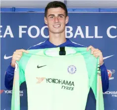  ??  ?? Kepa holds up a jersey as he attend his unveiling press conference at Stamford Bridge in west London. — AFP photo