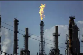  ?? GREGORY BULL — THE ASSOCIATED PRESS FILE ?? A flame burns at the Shell Deer Park oil refinery in Deer Park, Texas. Companies have reported that roughly two dozen storage tanks holding crude oil, gasoline and other fuels collapsed or otherwise failed during Harvey, spilling a combined 140,000...