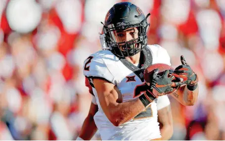  ?? [PHOTO BY BRYAN TERRY, THE OKLAHOMAN] ?? Oklahoma State receiver Tylan Wallace, a finalist for the Biletnikof­f Award, has excelled in his sophomore season, while his twin brother, Tracin, has missed most of the season because of an ACL injury.