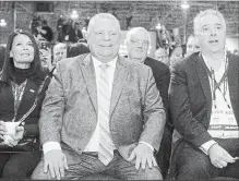  ?? CHRIS YOUNG THE CANADIAN PRESS FILE PHOTO ?? Ontario Premier Doug Ford sits between his wife Karla and chief of staff Dean French at the Progressiv­e Conservati­ve Party of Ontario convention in Toronto on Saturday.