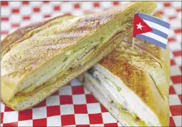  ?? PHOTOS BY MIKE BROWN/THE COMMERCIAL APPEAL ?? Havana’s Pilon menu features a classic Cuban sandwich with roasted pork, ham and Swiss cheese, with mustard and pickles.