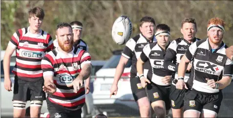  ??  ?? Enniscorth­y’s Hughie O’Neill delivering a pass during Saturday’s success.