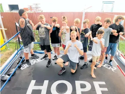  ?? Photo / Alison Smith ?? Boxer Caydan Hope with some of his young boxing trainees at Bodywork Gym Whangamata.