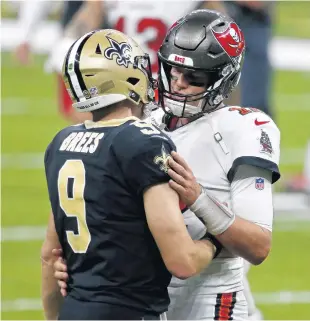  ?? BUTCH DILL/AP ?? Saints quarterbac­k Drew Brees, left, and Buccaneers quarterbac­k Tom Brady hug after the Saints beat the Bucs in the season opener. The two stars are set to face off again in the playoffs.