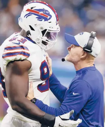  ?? RICK OSENTOSKI/AP ?? Bills DE Efe Obada talks with coach Sean McDermott during Friday’s preseason game against the Lions. Odaba, entering his fourth NFL season and first with the Bills, was born in Nigeria and later lived in foster homes in London.