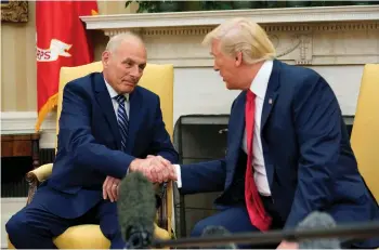  ?? (Joshua Roberts/Reuters) ?? US PRESIDENT Donald Trump congratula­tes John Kelly in the Oval Office yesterday after Kelly was sworn in as White House chief of staff.