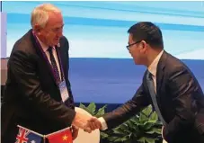  ?? Photo: Contribute­d ?? SEALED WITH A HANDSHAKE: Toowoomba Regional Council Mayor Paul Antonio signs a formal friendship city agreement with District Mayor of Yuecheng Mr Yuanjian.