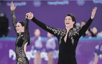  ?? PAUL CHIASSON THE CANADIAN PRESS ?? Canada’s Tessa Virtue and Scott Moir salutes the crowd following their performanc­e the ice dance figure skating short program Monday.