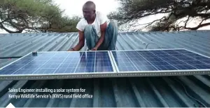  ??  ?? Sales Engineer installing a solar system for Kenya Wildlife Service’s (KWS) rural field office