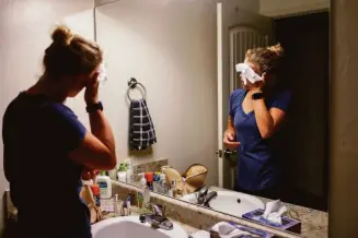  ?? ?? Taub cleans her face early in the morning as she gets ready to go to the clinic. The Supreme Court will hear a case Wednesday that could gut the landmark 1973 Roe vs. Wade decision.