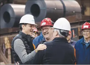  ?? CP PHOTO ?? Prime Minister Justin Trudeau meets with workers during a tour of the Direct Strip Production Complex at Essar Steel Algoma in Sault Ste. Marie, Ont., on Wednesday.