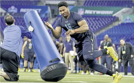  ?? MICHAEL CONROY/THE ?? Texas A&M defensive end Myles Garrett runs a drill at the NFL football scouting combine in Indianapol­is, on Sunday.