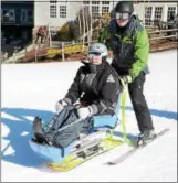  ?? AP FILE PHOTO ?? With the help of Clarlie Reutemann, Don Tallman of Glenville gets ready to ride the chairlift after coming down in a bi-ski at Jiminy Peak in Hancock. Massachuse­tts during a weekend of lessons offered for disabled veterans by STRIDE Adaptive Sports in...