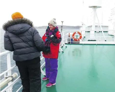  ?? JOHN PEIRSON ?? Marny Peirson chats on the deck of the Russian ship Akademik Ioffe before it struck a rock in the Arctic Ocean and began to list.