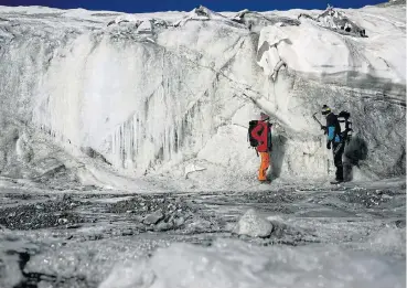  ?? /Reuters ?? Vanishing history: Glaciologi­st Andrea Fischer and environmen­tal physicist Pascal Bohleber from the Austrian Institute for Interdisci­plinary Mountain Research, inspect the thickness difference of a part of Schaufelfe­rner glacier, near Neustift in Stubaital, Austria.