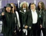  ?? STUART RAMSON — THE ASSOCIATED PRESS FILE ?? In this file photo, members of Lynyrd Skynyrd, from left, Gary Rossington, Billy Powell, Artimus Pyle, Ed King and Bob Burns, appear backstage after being inducted at the annual Rock and Roll Hall of Fame dinner in New York. A family statement said King, who helped write several of their hits including “Sweet Home Alabama,” died from cancer, Wednesday in Nashville, Tenn. He was 68.
