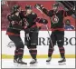  ?? JUSTIN TANG — AP ?? Ottawa’s Tim Stutzle, center, celebrates his winning goal against Edmonton with Thomas Chabot and Austin Watson.