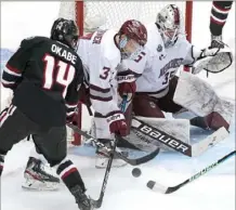  ??  ?? Massachuse­tts goaltender Filip Lindberg makes save against St. Cloud State’s Zach Okabe, one of 25 he made en route to a shutout.