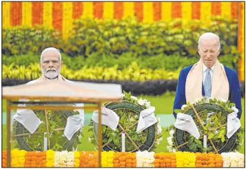  ?? Kenny Holston The Associated Press ?? President Joe Biden, right, and Indian Prime Minister Narendra Modi pay their tributes at the Rajghat, a Mahatma Gandhi memorial, on Sunday in New Delhi, India.