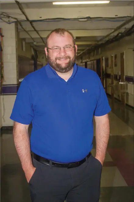  ?? MARK BUFFALO/THREE RIVERS EDITION ?? Clint Williams, standing in the hallway at Hazen High School, was recently hired as the new principal at Bald Knob High School. Williams has been the Hazen principal the past two years. He got his start in education during the 2011-12 school year as a seventh-grade math teacher at Hazen.
