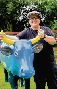  ??  ?? Justin Moorhouse with his Cow Parade cow.