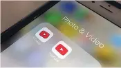  ?? AP Photo/Jenny Kane, File ?? ■ In this 2018 file photo, the YouTube app and YouTube Kids app are displayed on a smartphone in New York. A new survey confirms what a lot of parents already know: Teens and tweens are consuming a lot of online video, often on services such as YouTube.