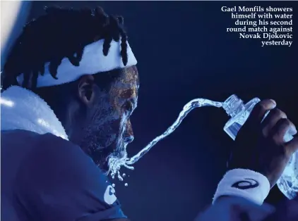  ??  ?? Gael Monfils showers himself with water during his second round match against Novak Djokovic yesterday