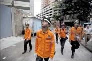  ?? AP/FERNANDO LLANO ?? Civil protection workers in Caracas, Venezuela, prepare to climb the abandoned Tower of David skyscraper and secure its top floors after Wednesday’s earthquake.