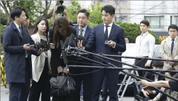  ?? AP PHOTO/AHN YOUNG-JOON ?? Former Korean Air Senior Vice President Cho Hyun-min, center, bows as she arrives at a police station in Seoul, South Korea, on Tuesday.