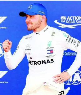  ??  ?? Mercedes driver Valtteri Bottas celebrates after setting the pole position during the qualifying session at the Barcelona Catalunya racetrack in Montmelo, just outside Barcelona, Spain, yesterday.