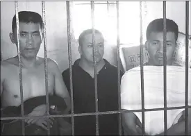  ??  ?? Screenshot shows the three suspected vigilantes behind bars after their arrest in Tondo, Manila.