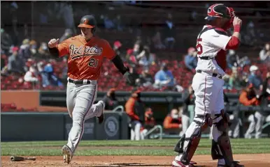  ?? Ap ?? Baltimore’s austin Hays scores behind red Sox catcher Kevin plawecki on a two-run single by Maikel Franco during the fourth inning of Saturday’s game in Boston.