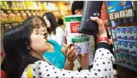  ?? LAM YIK-FEI / BLOOMBERG. ?? Dairy and babycare products in Hong Kong are among the hottest picks for Chinese mainland customers. The introducti­on of pilot mainland cities for cross-boundary e-commerce has made the inspection and quarantine procedures much simpler, according to...