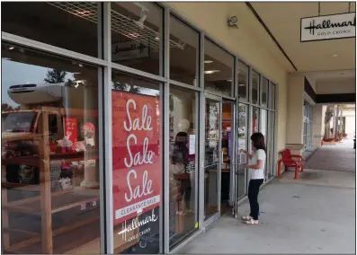  ?? (AP/John Raoux) ?? A sale sign is on display Tuesday near the entrance of a Hallmark store in Orlando, Fla. A rise in gasoline prices pushed consumer prices up 0.4% in December.